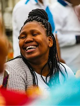A woman smiling during an education programme