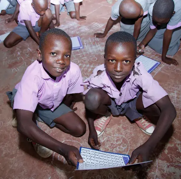 Children reading together outdoors